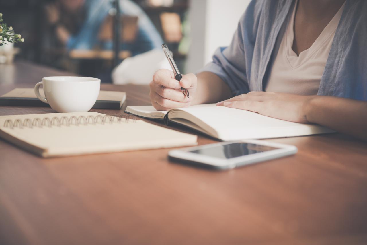 image of a woman working at her table with a coffee