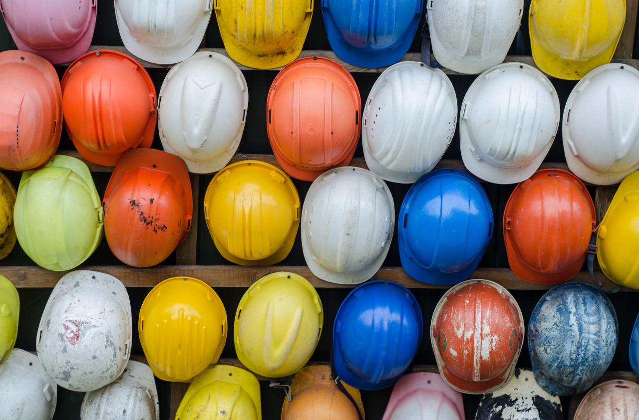 image of the tops of multi-coloured construction hats