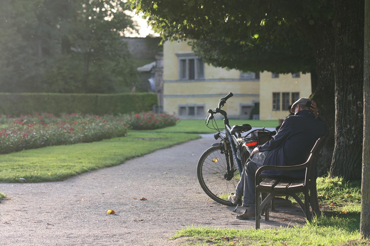 image of elderly man on a park bench