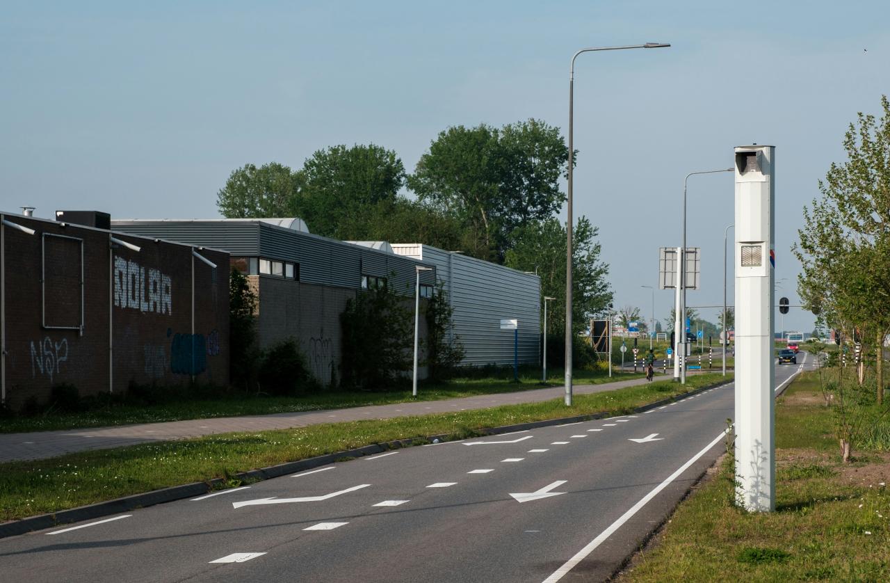Image of a nondescript road with a speed camera on it courtesy of unsplash and the photographer haberdoedas ii 