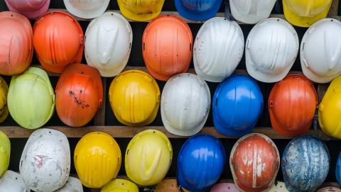 image of the tops of multi-coloured construction hats