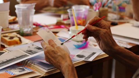 image of people's hands working at crafts