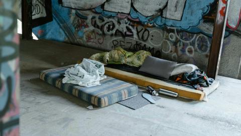 Image of empty bed on street courtesy of Mart Productions through Pexels